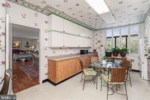 kitchen featuring light hardwood / wood-style flooring and white cabinets