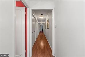 hall with hardwood / wood-style flooring