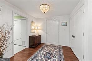 corridor with dark hardwood / wood-style flooring