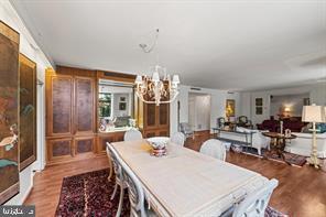 dining area with hardwood / wood-style flooring and a chandelier