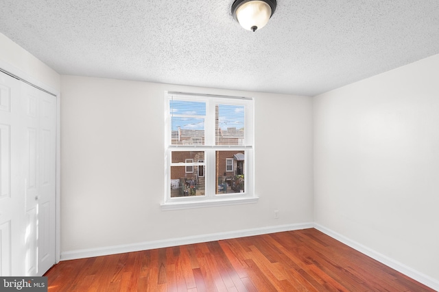 interior space with hardwood / wood-style flooring and a textured ceiling