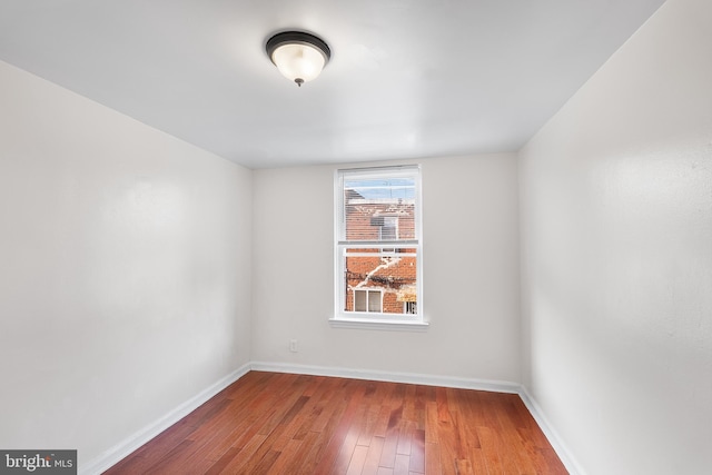 unfurnished room featuring hardwood / wood-style flooring