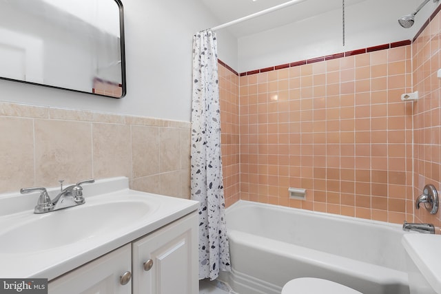 full bathroom featuring vanity, tile walls, shower / bath combo, and toilet