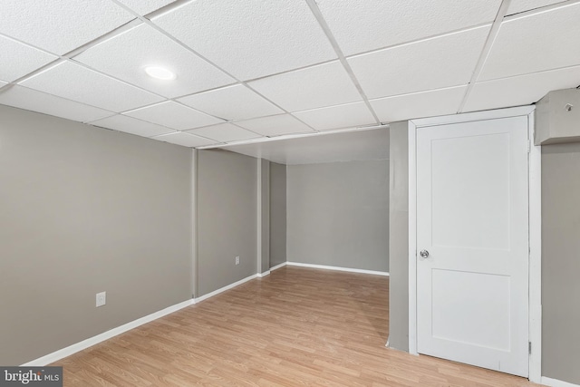 basement with hardwood / wood-style floors and a drop ceiling