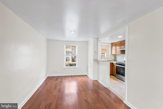 unfurnished living room featuring hardwood / wood-style flooring