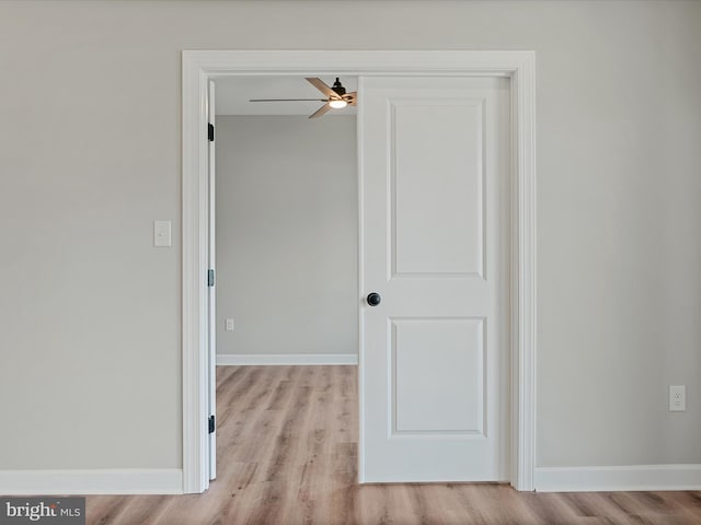 empty room with a ceiling fan, baseboards, and wood finished floors