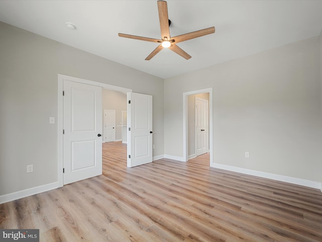 unfurnished bedroom with a ceiling fan, baseboards, and light wood finished floors