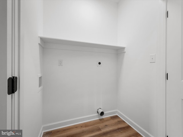 laundry area featuring laundry area, wood finished floors, baseboards, hookup for a washing machine, and hookup for an electric dryer