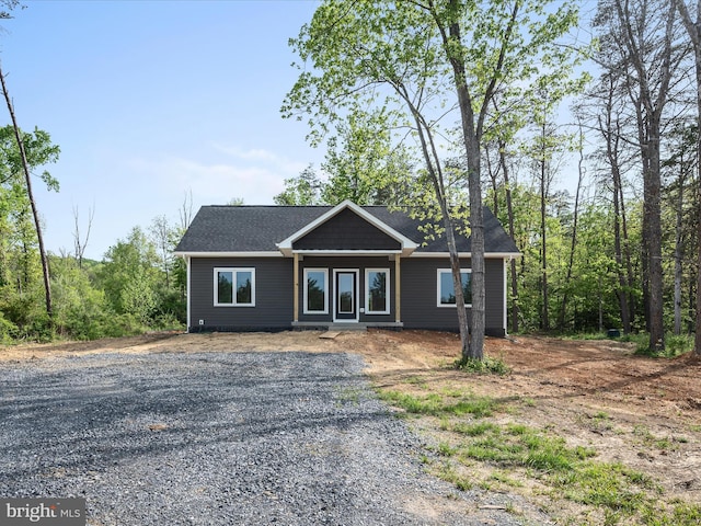 ranch-style house with gravel driveway