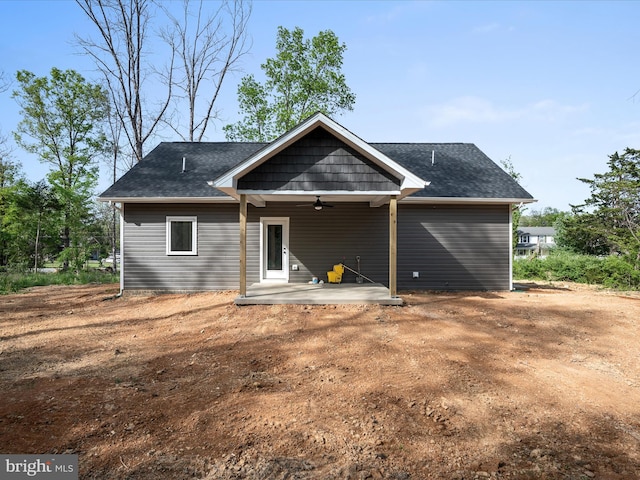 rear view of house featuring roof with shingles, ceiling fan, and a patio area