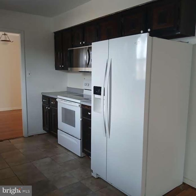 kitchen featuring dark brown cabinets and white appliances