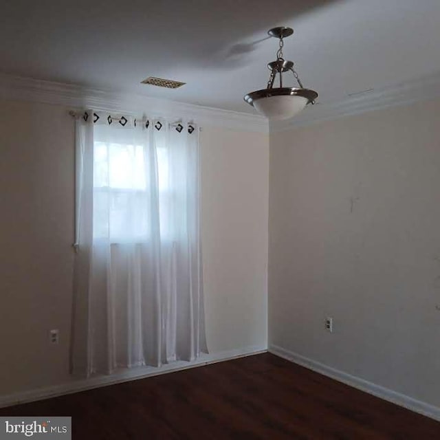 unfurnished room featuring crown molding and dark wood-type flooring