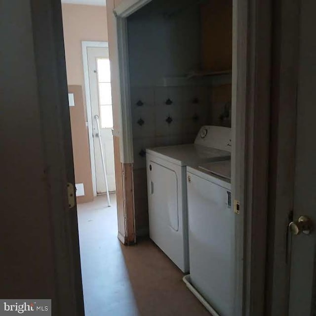 laundry area with independent washer and dryer