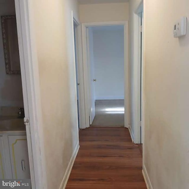 corridor with dark wood-type flooring