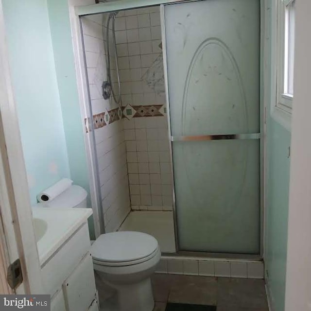 bathroom with vanity, toilet, and an enclosed shower