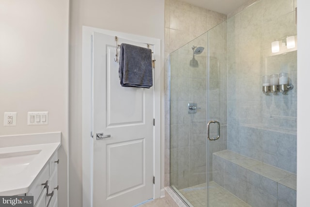 bathroom featuring walk in shower and vanity