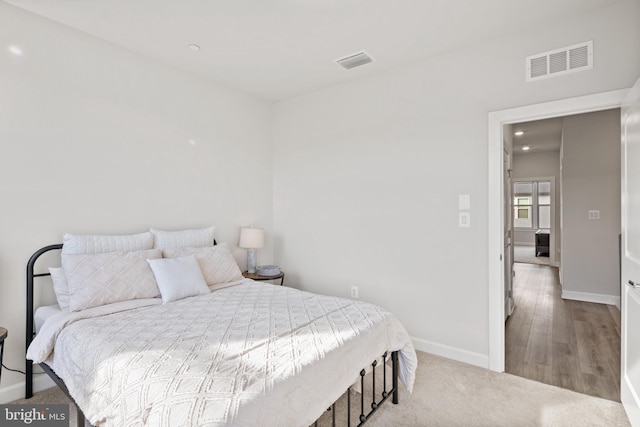 bedroom featuring light carpet