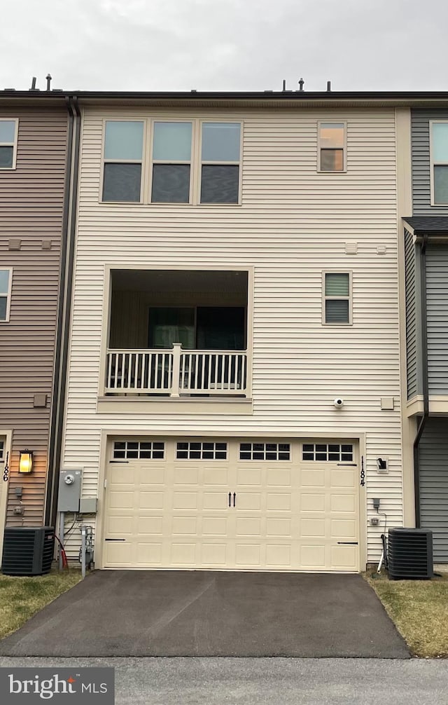 exterior space featuring a garage and central AC