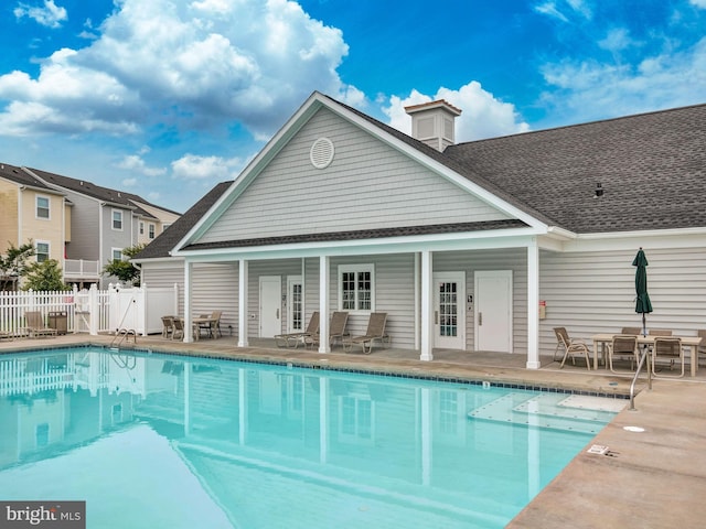 view of swimming pool with an outdoor structure and a patio