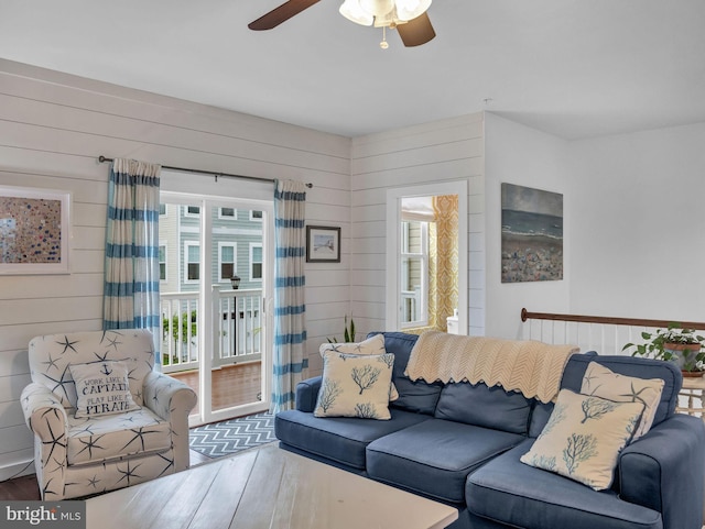 living room featuring hardwood / wood-style floors and ceiling fan