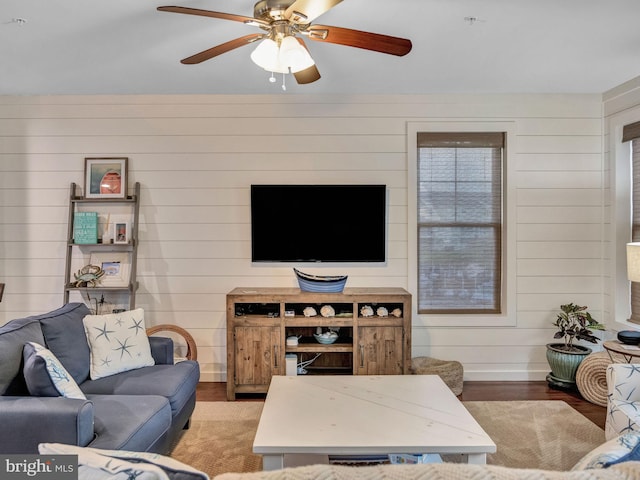 living room featuring hardwood / wood-style flooring and ceiling fan