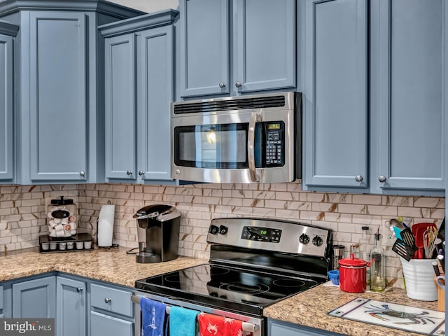 kitchen featuring stainless steel appliances and blue cabinets