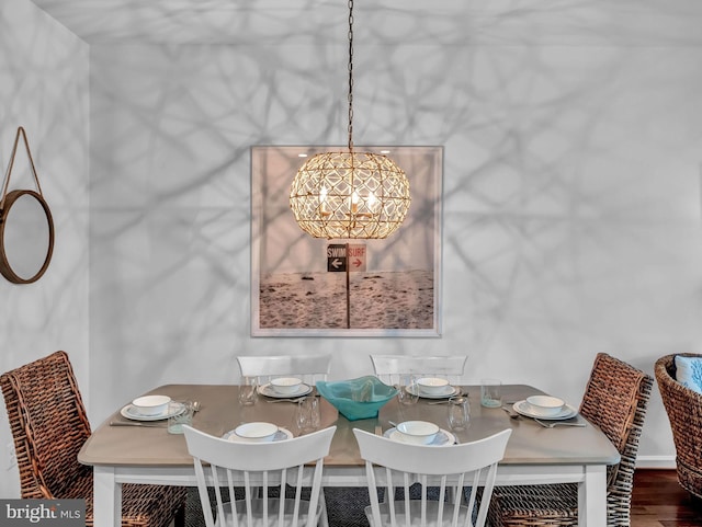 dining area with an inviting chandelier and hardwood / wood-style flooring