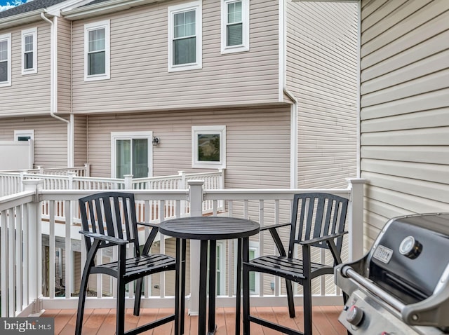 wooden balcony with area for grilling and a deck