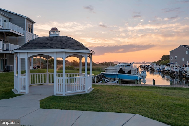 surrounding community featuring a yard, a gazebo, a dock, and a water view