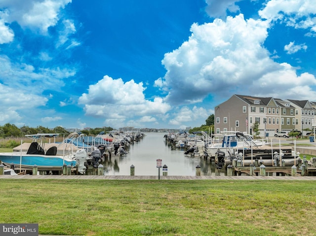 view of dock featuring a water view and a lawn