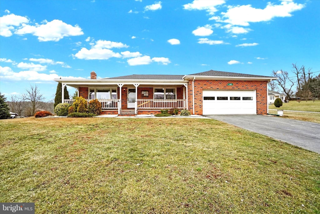 ranch-style house with a porch, a garage, and a front lawn