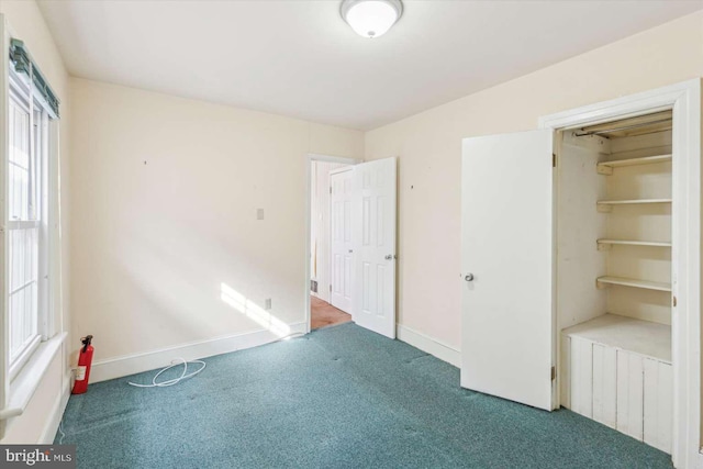 unfurnished bedroom with carpet and a closet