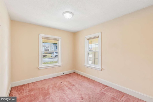 carpeted empty room featuring a healthy amount of sunlight