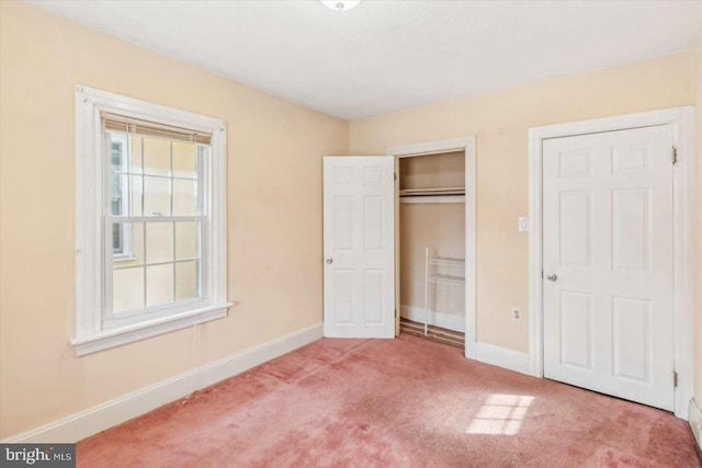 unfurnished bedroom with carpet flooring and a closet