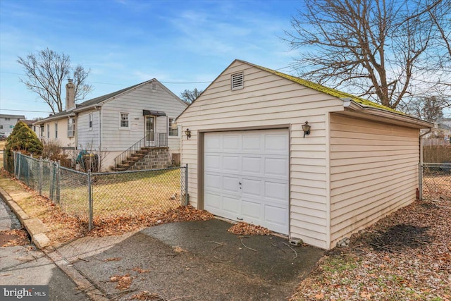 exterior space with a garage, an outdoor structure, and a front yard