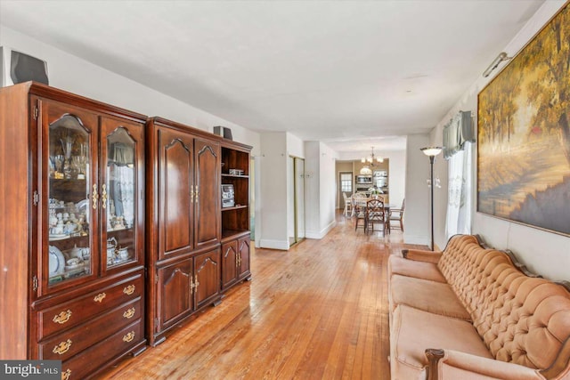 living room featuring light hardwood / wood-style floors and a notable chandelier