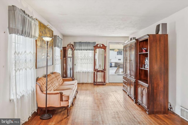 living area with hardwood / wood-style flooring