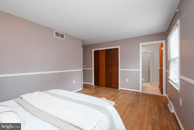 bedroom featuring a closet and light hardwood / wood-style flooring