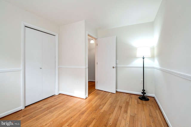 unfurnished bedroom featuring a closet and light hardwood / wood-style flooring