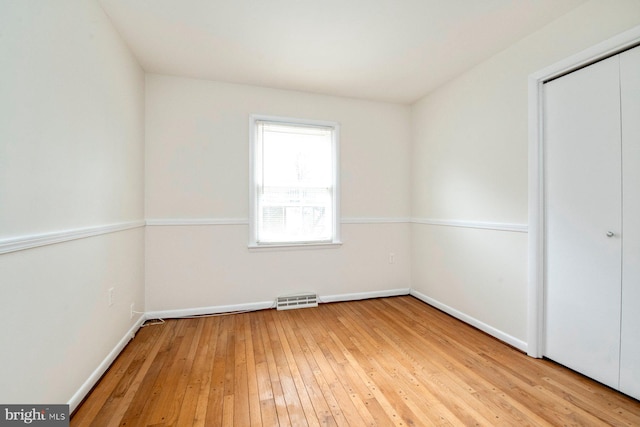 unfurnished bedroom featuring hardwood / wood-style flooring and a closet