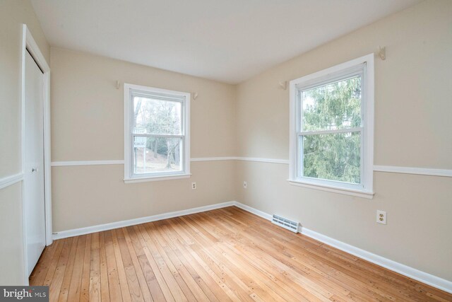 spare room featuring light wood-type flooring