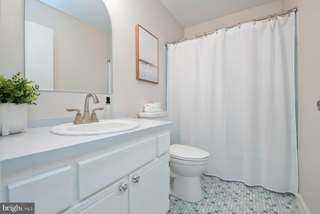 bathroom featuring tile patterned flooring, vanity, and toilet