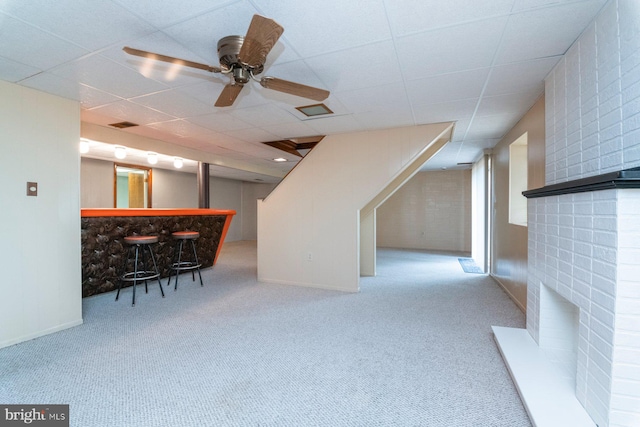 bonus room featuring bar, light colored carpet, and ceiling fan