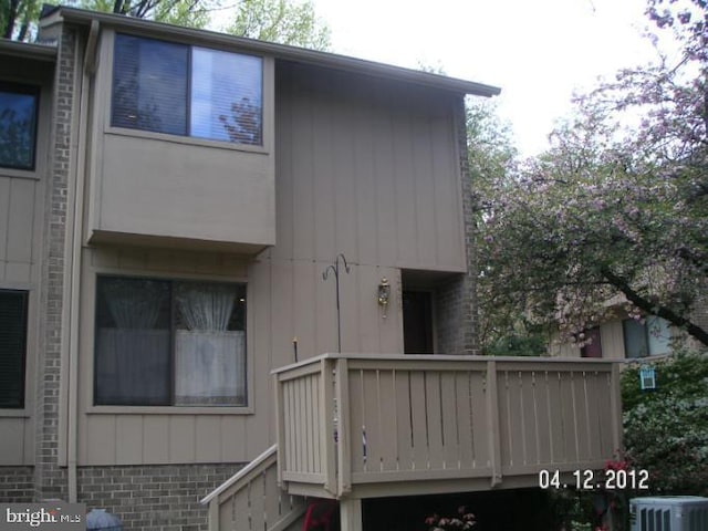 exterior space with central AC unit and a balcony