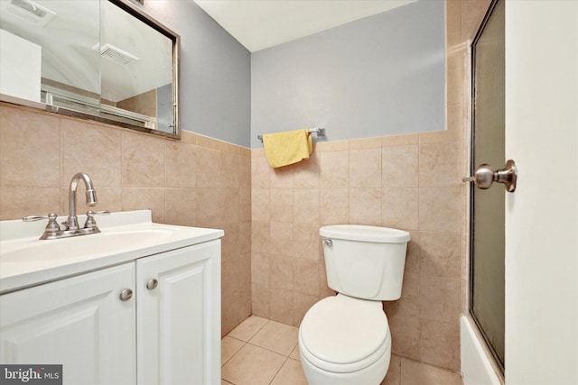 full bathroom featuring tile walls, tile patterned flooring, vanity, enclosed tub / shower combo, and toilet