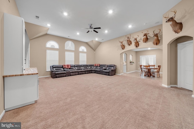 carpeted living room featuring ceiling fan