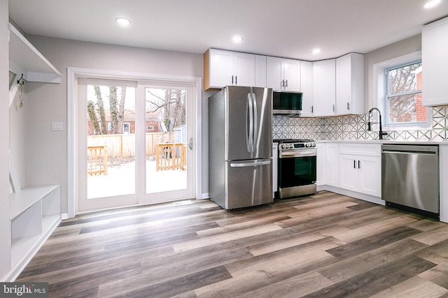 5006 Edgewood Rd, College Park, MD 20740 - kitchen featuring sink, stainless steel appliances, hardwood / wood-style floors, and white cabinets