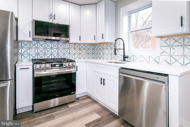 5006 Edgewood Rd, College Park, MD 20740 - kitchen with white cabinetry, stainless steel appliances, and sink