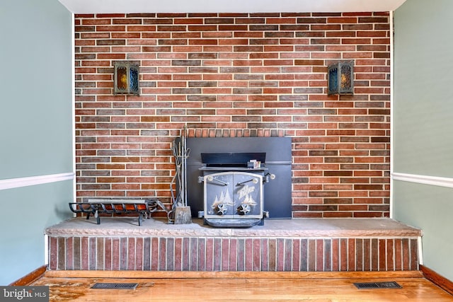 room details featuring wood-type flooring and a wood stove