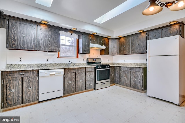 kitchen featuring white appliances, a skylight, sink, and dark brown cabinets